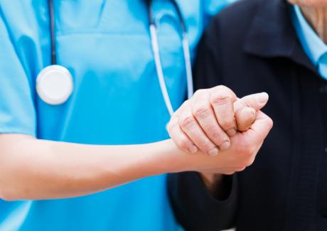 Doctor holding patient hand