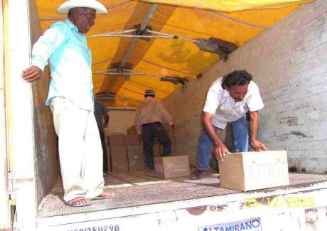 Workers unload boxes