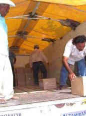 Workers unload boxes